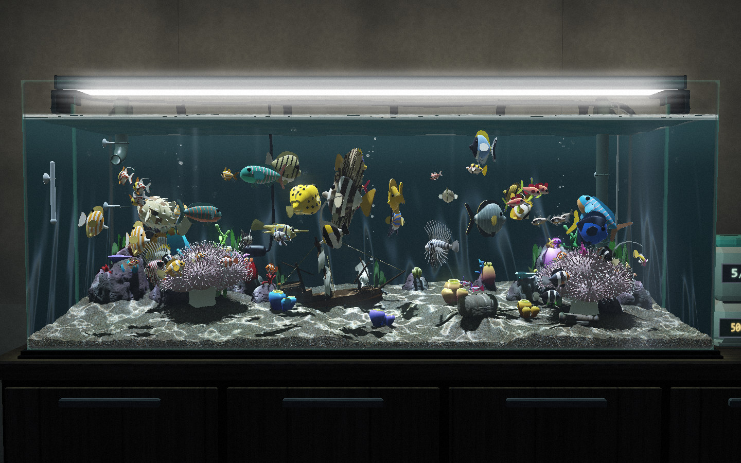 120cmまで広げたリーフ水槽。ライトに照らされた岩とイソギンチャクの間を、色とりどりの魚が数十匹泳いでいる